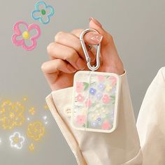 a person holding a keychain with flowers on it, and the image is being projected