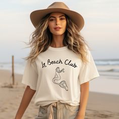 Welcome to Le Beach Club! Get ready for warm weather in our trendy Mermaid Le Beach Club T-Shirt. The effortless minimalist design will go with everything in your wardrobe and quickly become your favorite tee. Our mermaid tee makes the cutest summer gifts and perfect for vacations! Comfort Colors garment-dyed t-shirt; a fully customizable tee made 100% with ring-spun cotton. The soft-washed, garment-dyed fabric brings extra coziness to your wardrobe while the relaxed fit makes it an excellent daily choice. The double-needle stitching throughout the tee makes it highly durable while the lack of side-seams helps the shirt retain its tubular shape.  .: The Comfort Colors 1717 tee is made with medium fabric (6.1 oz/yd² (206.8 g/m consisting of high quality, 100% ring-spun US cotton for long-la Summer Graphic Tee, Club T Shirt, Summer Gifts, Club Shirts, Beach Shirt, Comfort Color, Beach Shirts, Trendy Tshirts, Dyed Fabric