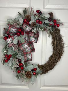 a christmas wreath hanging on the front door