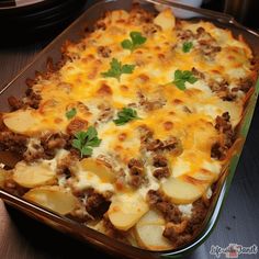 a casserole dish with potatoes, meat and cheese