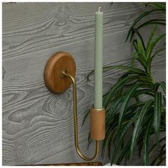 a wall mounted candle holder with a wooden handle