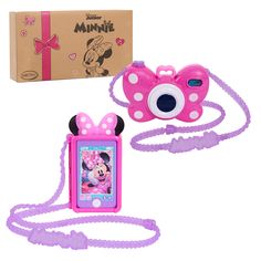 a pink camera with minnie mouse on it next to a cardboard box and a purple strap