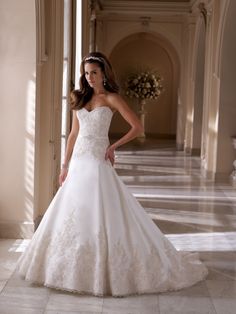 a woman in a wedding dress posing for the camera