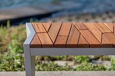 a wooden bench sitting on top of a sidewalk