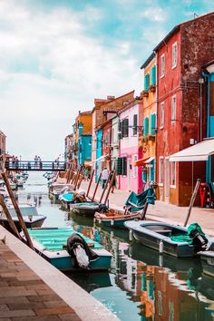 the boats are parked along the side of the water