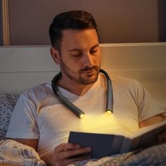 a man reading a book while wearing a stethoscope