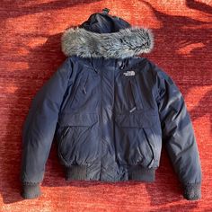 Women’s Size Medium Goose Down North Face Gotham Bomber Jacket With Faux Fur Hood Trim. Very Warm And Comfortable I Just Have Too Many Jackets. In Great Used Condition With Minor Pilling That Can Be Remedied. One Cuff Is More Worn From It Catching On The Velcro But You Don’t See It When It’s On. All Zippers Work, No Tears Or Marks - Smoke And Pet Free Home. The North Face Winter Outerwear With Pockets, The North Face Winter Workwear Outerwear, Fur Hood, Black North Face, The North Face Jackets, North Face Women, North Face Jacket, Gotham, North Face