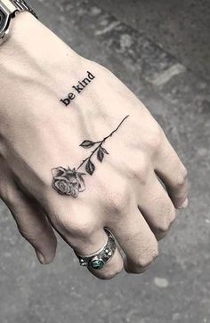 a person's hand with a rose tattoo on it and the words dear written in black ink