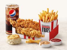 an image of fried chicken and french fries with ketchup on the side next to a can of pepsi