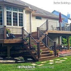 a house with a deck and stairs in the front yard