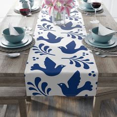 the table is set with blue and white place mats, napkins, and cups