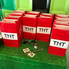 there are many red bags that say ttt and have sunglasses on top of them