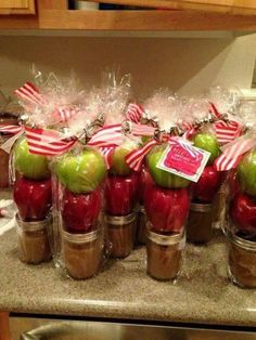 an image of homemade caramel sauce in jars with apples and candy canes on top