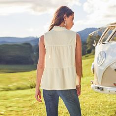 This beige knit blouse showcases a standing collar and a split neckline with a tie closure, adding a sophisticated touch. Sleeveless and finished with front buttons, it's ideal for a polished look in warmer weather or for layering under a blazer. Whether you're running errands, hitting the gym, or enjoying a casual day out, this tank top will keep you feeling cool and looking fabulous. Product code: CAA04D4D008GG Beige Sleeveless Blouse For Day Out, Feminine Cream Sleeveless Blouse, Feminine Sleeveless Cream Blouse, Feminine Beige Sleeveless Blouse, Chic Sleeveless Beige Blouse, Chic Beige Vest Top, Beige Sleeveless Blouse For Summer, Casual Cream Sleeveless Blouse, Cream Sleeveless Blouse For Day Out