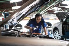 a woman working on an engine in a car showroom stock photos and pictures getty images black bedroom furniture sets home design ideas