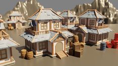 a bunch of houses that are sitting in the sand with barrels on each side and mountains behind them