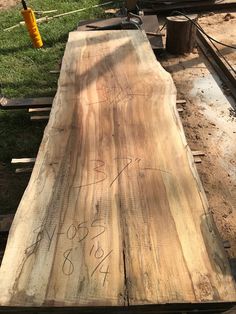 a large piece of wood sitting on top of a field