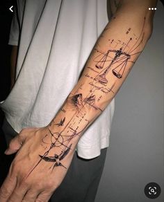 a person with a tattoo on their arm that has lines and shapes drawn on it