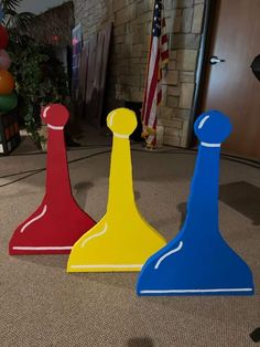 three different colored pawns sitting on the floor