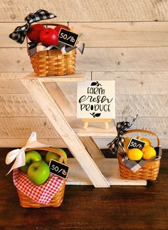 two baskets filled with apples and lemons on top of a wooden table next to a sign that says farm fresh produce