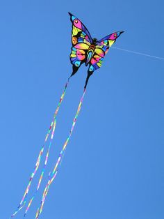 a colorful butterfly kite flying in the blue sky