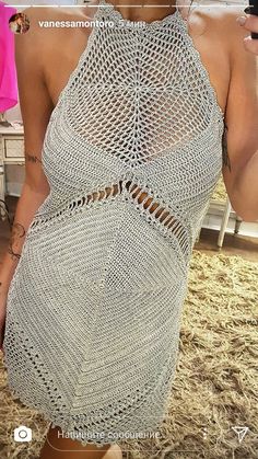 the back of a woman's dress with crochet on it