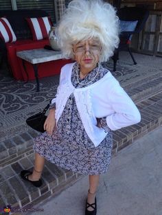 an older woman with white hair is standing on the steps