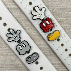 two white watch bands with mickey and minnie mouse designs on them