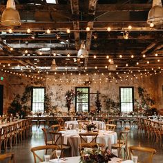 an indoor wedding venue with tables and chairs