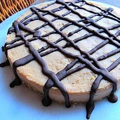 a cake with chocolate drizzled on it sitting on top of a blue plate