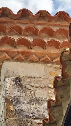 a bird is perched on the roof of a building