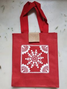 a red bag with white designs on it