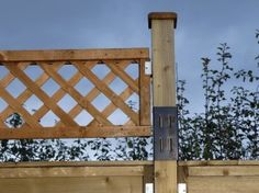 a wooden fence with a metal gate on top