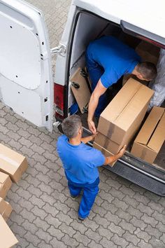 two men unloading boxes from the back of a van