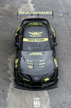 the front end of a race car with yellow lettering on it's hoods