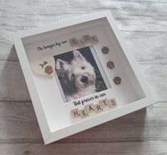 a white frame with a dog's photo and words on the front that says, the lessons by you side but people in fear hearts