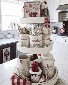 a stack of christmas mugs sitting on top of a kitchen counter