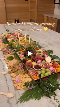 a table topped with lots of food on top of a white marble countertop next to wooden utensils