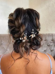 the back of a woman's head with flowers in her hair