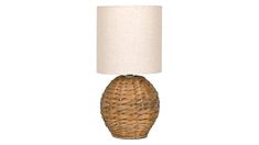 a wicker table lamp with a white shade