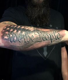 a man with a long beard has a tattoo on his arm that says we be people