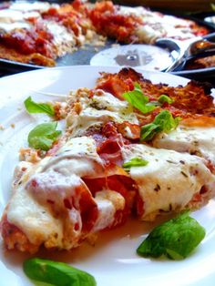 two slices of pizza sitting on top of a white plate next to another slice of pizza