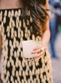 a close up of a person holding a drink