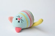 a crocheted stuffed animal laying on top of a white surface