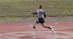 a man running on a track in the rain