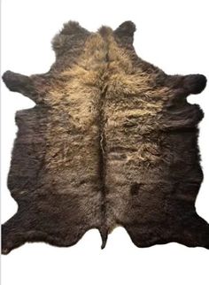 a brown and black cowhide rug on a white background with the top part of it showing