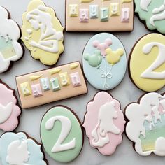 decorated cookies with the numbers two, three and six on top of each other in pastel colors