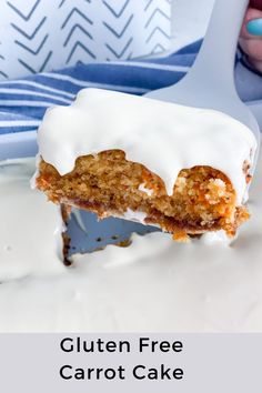 a close up of a piece of cake on a plate with icing and a spoon