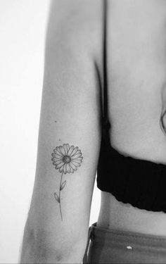 a woman with a flower tattoo on her arm