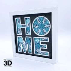 the word home is made out of cut paper and surrounded by blue snowflakes